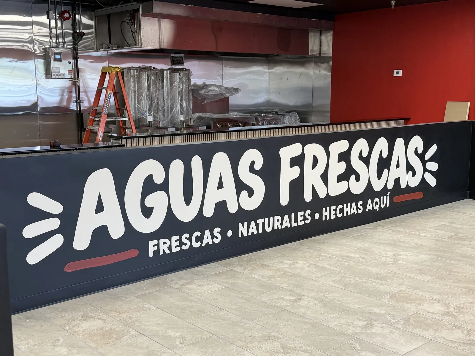 The Aguas Frescas counter mural at La Flama Taqueria